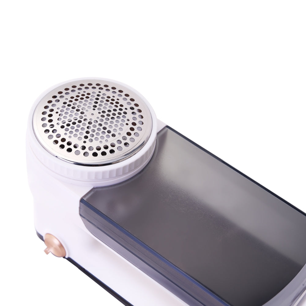 Fabric shaver with a white handle and metallic top on a white background