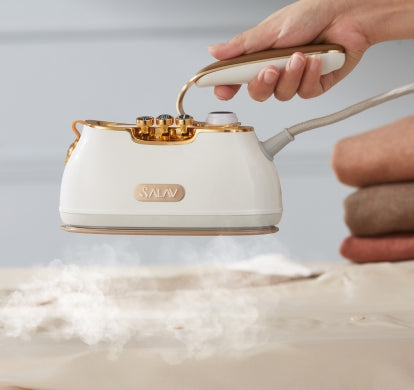 pearl IS900 retro steamer emitting steam over silk shirt