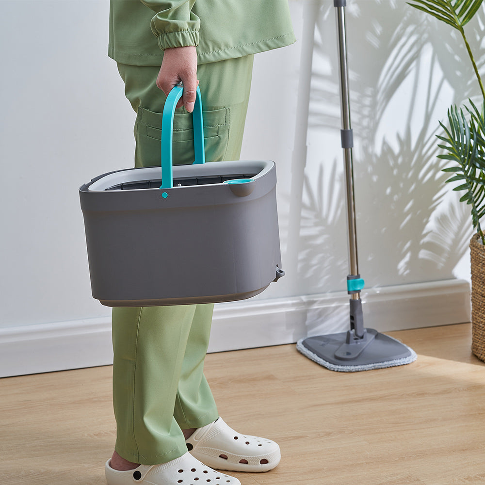SPIN800 + Gray + Cleaning-1 + person carrying bucket with spin mop resting on wall 