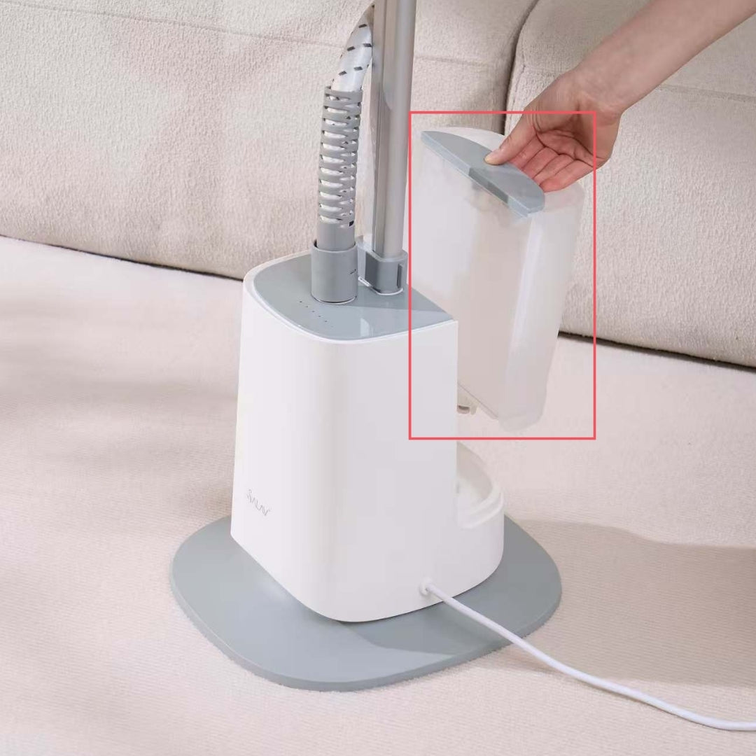 White handheld steamer with gray base on a beige surface