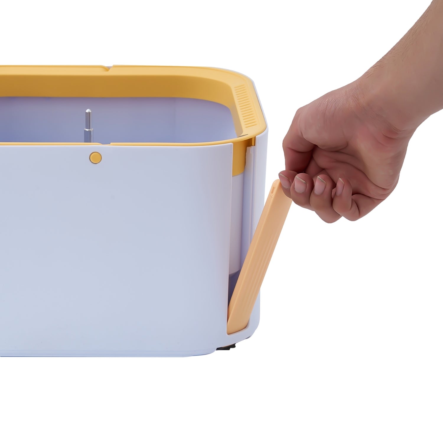 A hand is shown detaching the yellow  silicone scrub brush from a spin bucket container, photographed against a plain white background.