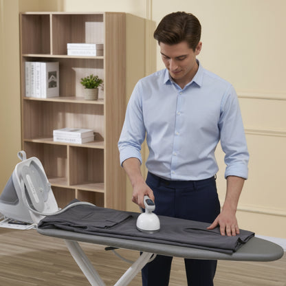 SS1500+White+Man ironing a shirt on an ironing board in a room with a bookshelf.