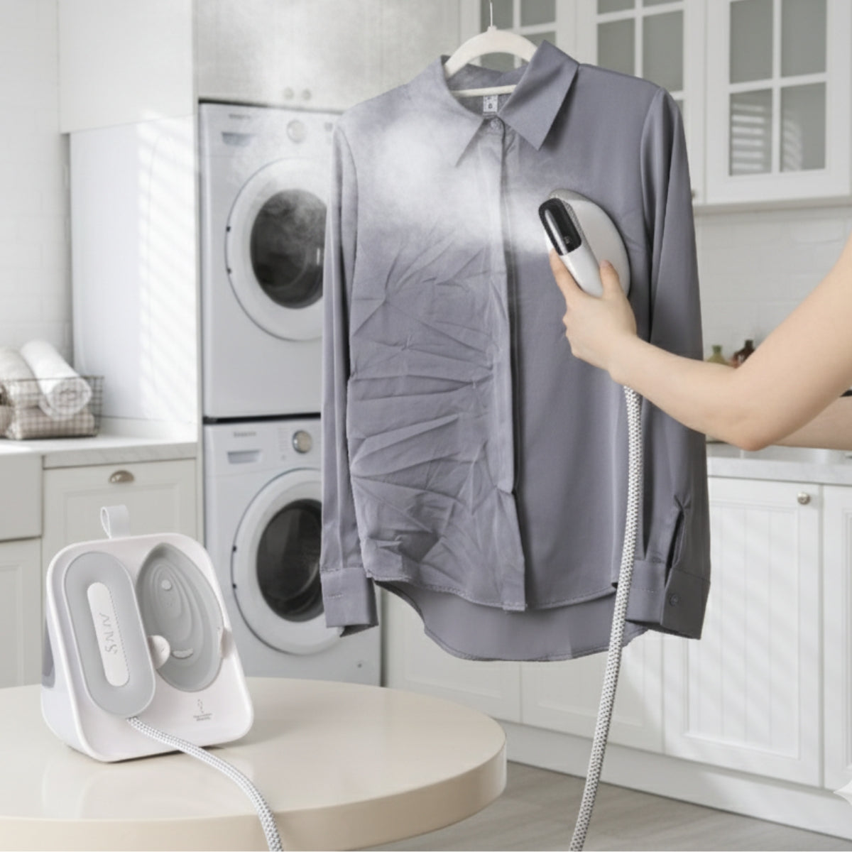SS1500+White+Person using a handheld steamer on a shirt in a laundry room with washing machines.