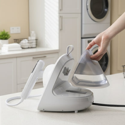 SA1500Tank+White+ garment steamer on a counter with a hand holding its handle.